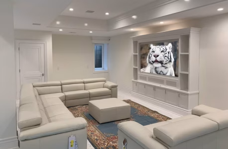 A modern living room with light-colored sofas, a rug, and a TV displaying an image of a white tiger.