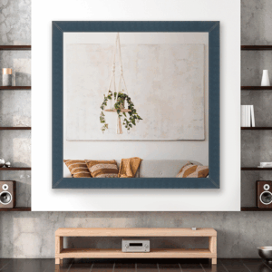 Framed art above a modern wooden media console; shelves with speakers and decor on both sides of the wall.